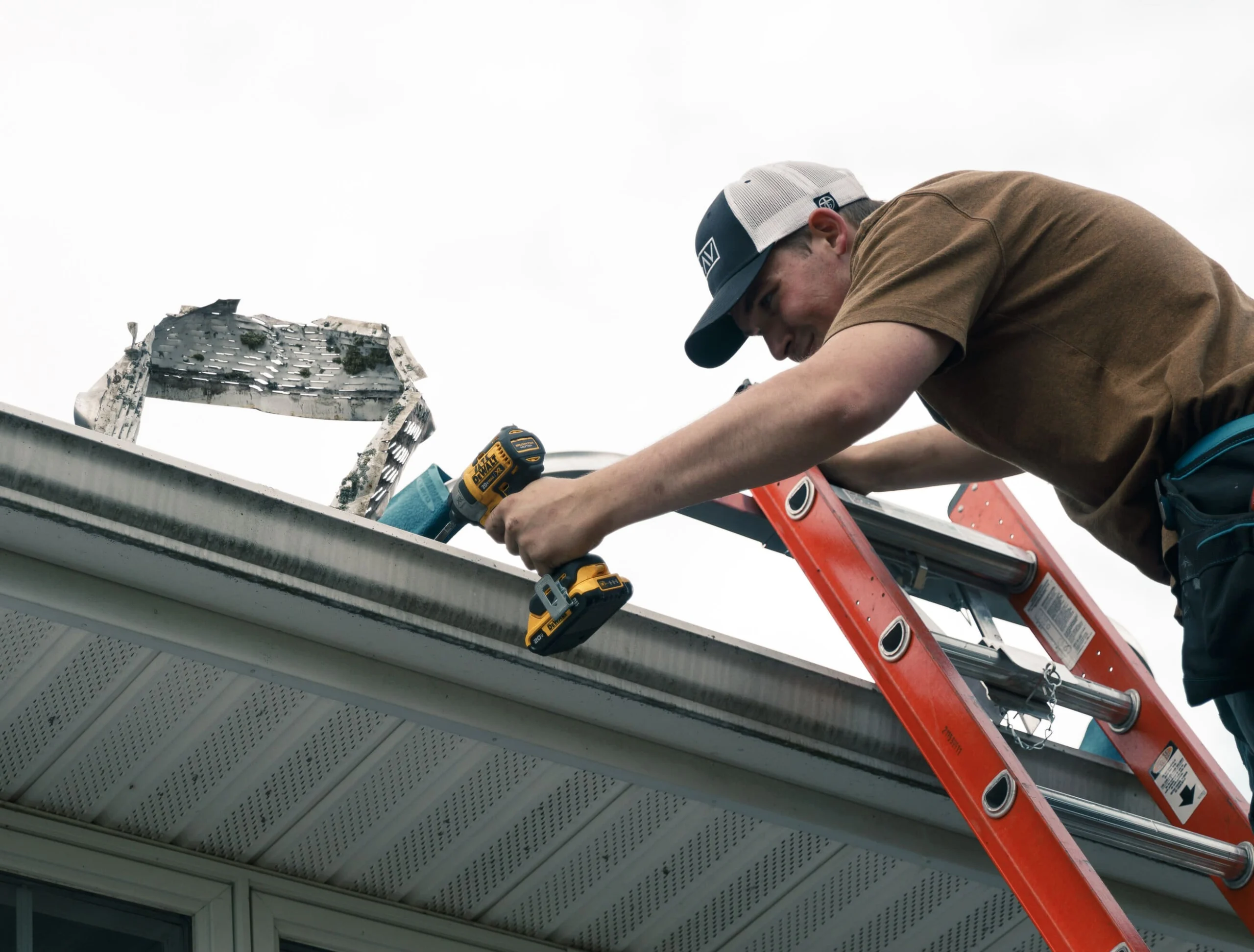 Pearson Seamless Gutters employee fixing bad gutters